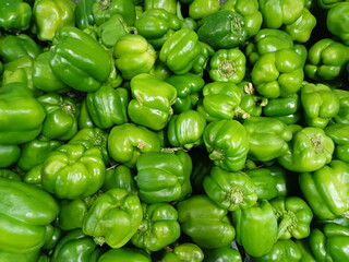 Shiny fresh Green Bell Peppers (Capsicum) captured on market