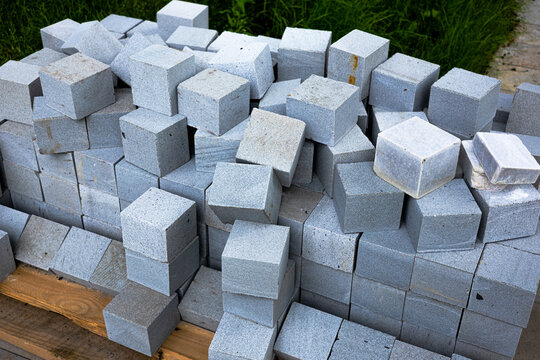 Gray cubic paving slabs piled outside 