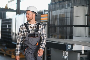 Factory worker. Man with helmet working with pvc