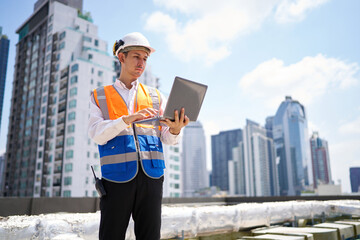 Engineer or worker working on laptop computer at construction site