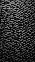 Fototapeta premium A textured black surface with wavy, undulating patterns resembling crumpled fabric or paper. The design creates a sense of depth and movement, ideal for backgrounds or abstract art.