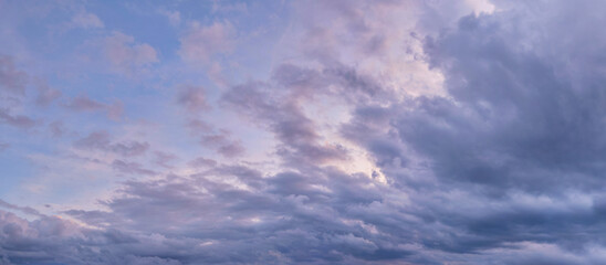 Dramatic cloudy sky on a fall evening. Panoramic sky photo, natural texture of clouds