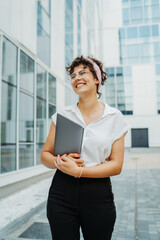 Young successful woman is going to work at modern business building