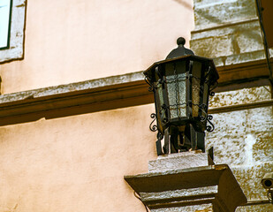 One old black iron lantern with white glass