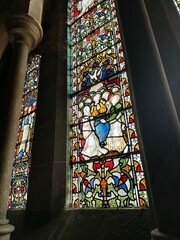 Very colorful stained glass window in a church in Dublin, Gothic Irish architecture, religious...