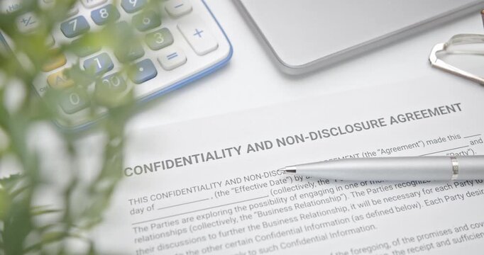 Blue pen on a confidentiality and non-disclosure agreement form. A confidentiality and non-disclosure agreement form safeguards sensitive information, outlining obligations, exceptions, and remedies.