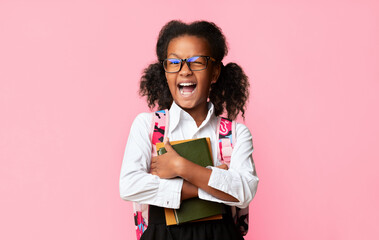 Excited Afro Elementary Student Girl Winking At Camera Over Yellow Studio Background. Back To...