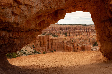 Dizzying Layers of Hoodoos Through Tunnel over Trail