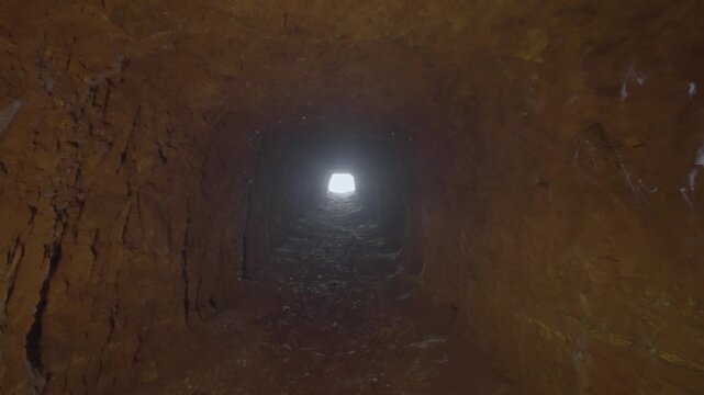 n the mine exploration tunnel, the camera moves to the illuminated entrance of the tunnel