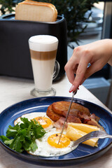 Cut fried eggs in a plate. Breakfast.