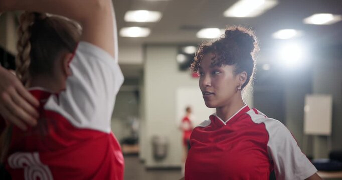 Soccer player women, stretching and talking in locker room of venue for game, match or sports. Exercise, fitness and warm up with friends getting ready for football challenge, competition or training