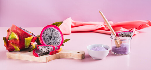 Pink matcha powder in a bowl and fresh dragon fruit on the table web banner