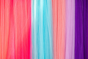 Psychedelic multicolored background abstract. Rainbow colors. patterns background. Photo macro shot of pastel colored synthetic hair.