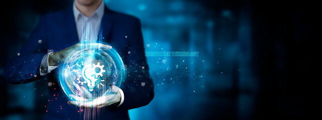 Fototapeta premium Innovation Technology: Businessman holding innovation technology to develop smart solutions from digital interfaces, cutting-edge advancements, creative problem-solving.