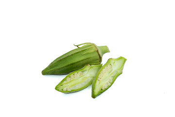 A whole and two pieces of a sliced green seedpods of okra (Abelmoschus esculentus) 