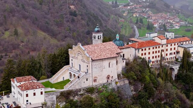 Cinematic aerial footage of Sanctuary Montecastello church on top mountain near Lake Garda in Italy