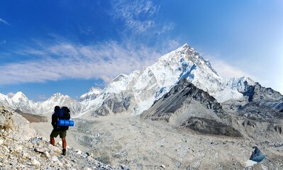 Fototapeta premium Hiker on morraine of Khumbu glacier and mount Nuptse