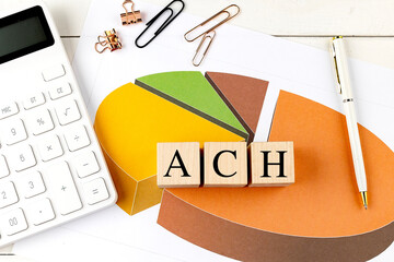 ACH word on wooden block on chart background