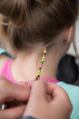 Hair braiding. Colorful string braided in.