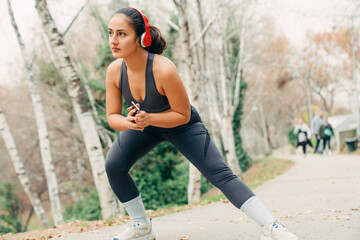 Young woman stretching before running in the park