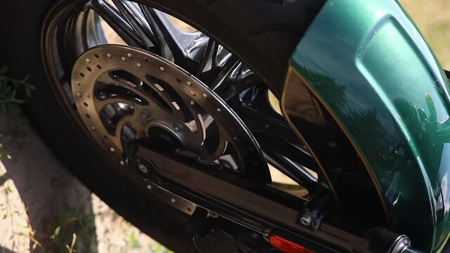 Tread on black tire on motorcycle wheel close up movie slow motion. Tire fitting concept