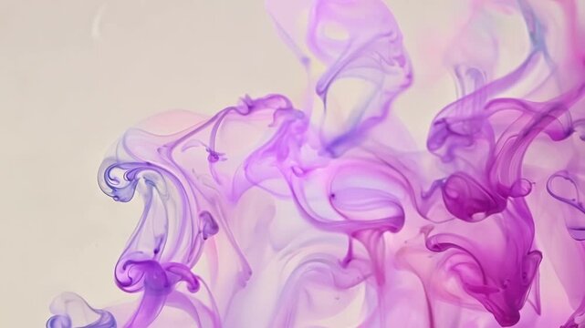 A macro shot of two colors of watercolor paint mixing and diffusing into each other creating a soothing blend.