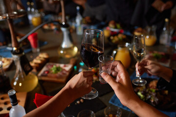At a lively nightclub, people are enjoying wine and socializing in a chic ambiance