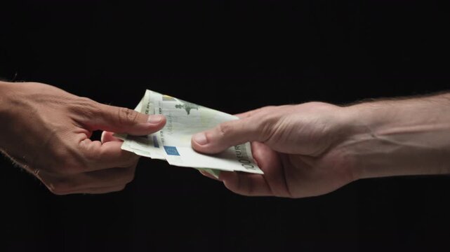 Hand Exchanges Money Secretly With Black Background