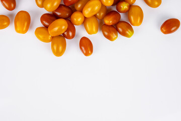 Vibrant cherry tomatoes spread on a white background. Ideal for food photography and healthy eating content, culinary websites and recipe blogs. Copy Space. Selective focus..