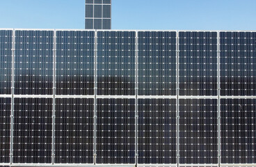 Solar cell plant. Aerial drone view of solar panels at the top of a building. Producing clean...
