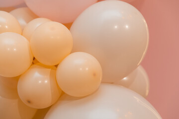 Pink and coral or  beige balloons of various sizes. Decorative wall. Volumetric decoration.