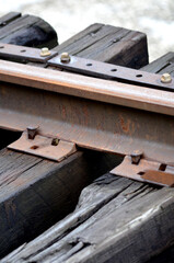 Close-up of Railroad track with rusty metal rail and wooden ties