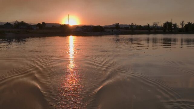 sunset over Boyd Lake with the sky obscured by smoke from Alexander Mountain Fire west of Loveland in Colorado as seen from a rowing shell