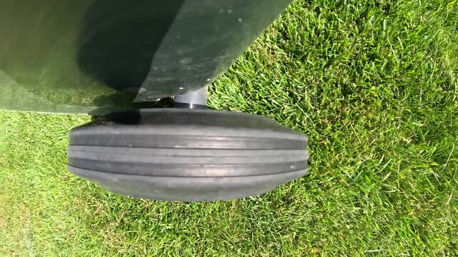 Close-up of the wheel of the trash can spinning