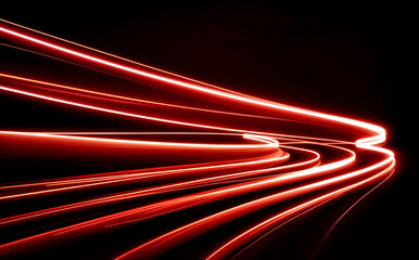 abstract of flowing light trails in vibrant shades of red and orange against a deep black background.