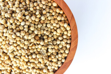 Close Up White pepper seeds or Peppercorns in a wooden bowl isolated on white background. Flat lay