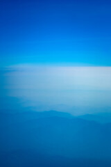 A blue sky with a few clouds. The sky is very clear and the clouds are small