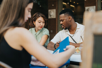 Diverse group of friends having a thoughtful conversation at an outdoor cafe, enjoying a relaxing day.