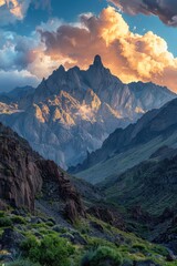 Obraz premium Majestic Mountain Range at Sunset with Dramatic Clouds and Rugged Terrain