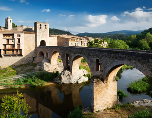 Obraz premium view of a medieval bulidings with towers and bridge in the greenery