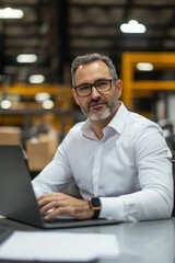 Obraz premium Portrait of a factory company manager at their desk with a laptop, Generative AI 
