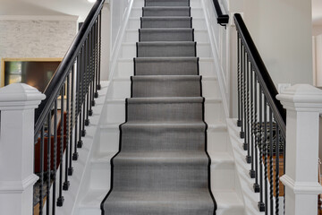 Modern Staircase With A Runner Carpet And Sleek Black Railing