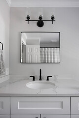 Stylish Bathroom With Square Mirror, Black Fixtures, And White Vanity