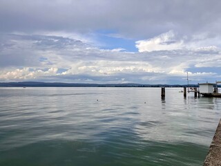 pier on the lake with clouds, calm before the storm