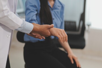 Doctor or Physiotherapist working examining treating injured arm of athlete male patient, stretching and exercise, Doing the Rehabilitation therapy pain in clinic.