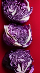 Obraz premium Close-up of sliced red cabbage against red background, vibrant and fresh vegetable concept