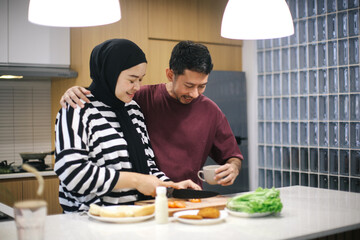 Happy Loving Asian Young Couple Cooking Food In Kitchen Together