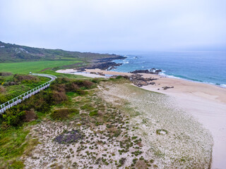 Aerial view, drone photo, ocean view in Portugal, beach in the morning, foggy day, seascape, camino road.