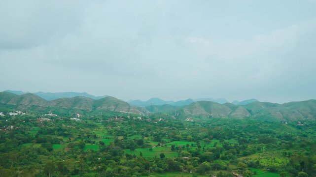 Rain clouds over lush green hills at Rayta, Rajasthan, India. Green landscape during monsoon season. Travel and holidays background. 