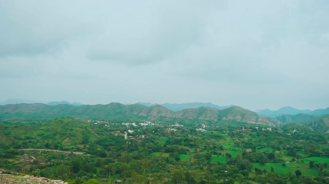 Rain clouds over lush green hills at Rayta, Rajasthan, India. Green landscape during monsoon season. Travel and holidays background. 